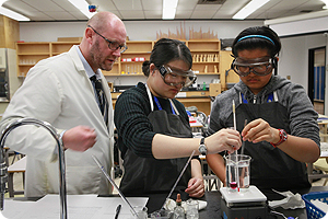 Teacher and students in science lab